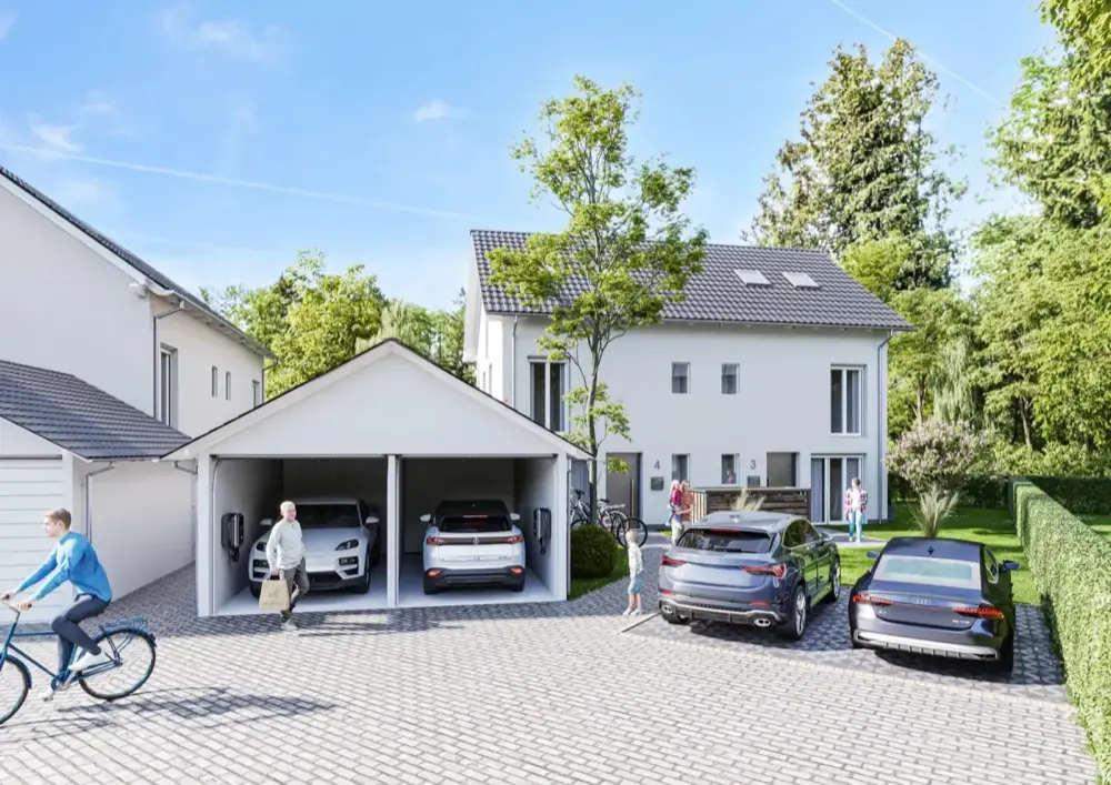 Einfahrt der Doppelhaushälfte in Karlsfeld mit Doppelgarage und E-Ladestationen